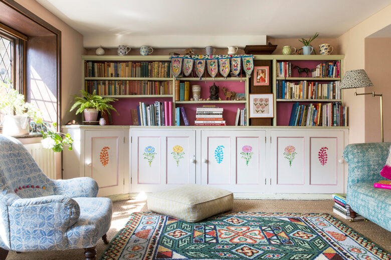 Open shelving, stencilled cupboards and hand block printed fabric in the living room of designer Molly Mahon in Ashdown Forest, East Sussex