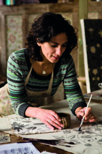 Decorative artist Melissa White painting in her studio in East Sussex, taken by photographer Liam Jones for Zoffany