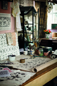 The East Sussex studio of decorative artist Melissa White, with examples of her designs with her paintbrushes and papers, taken by photographer Liam Jones for Zoffany